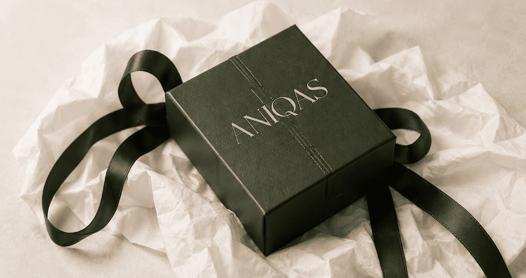 A personalised Aniqas jewellery gift, wrapped with a note